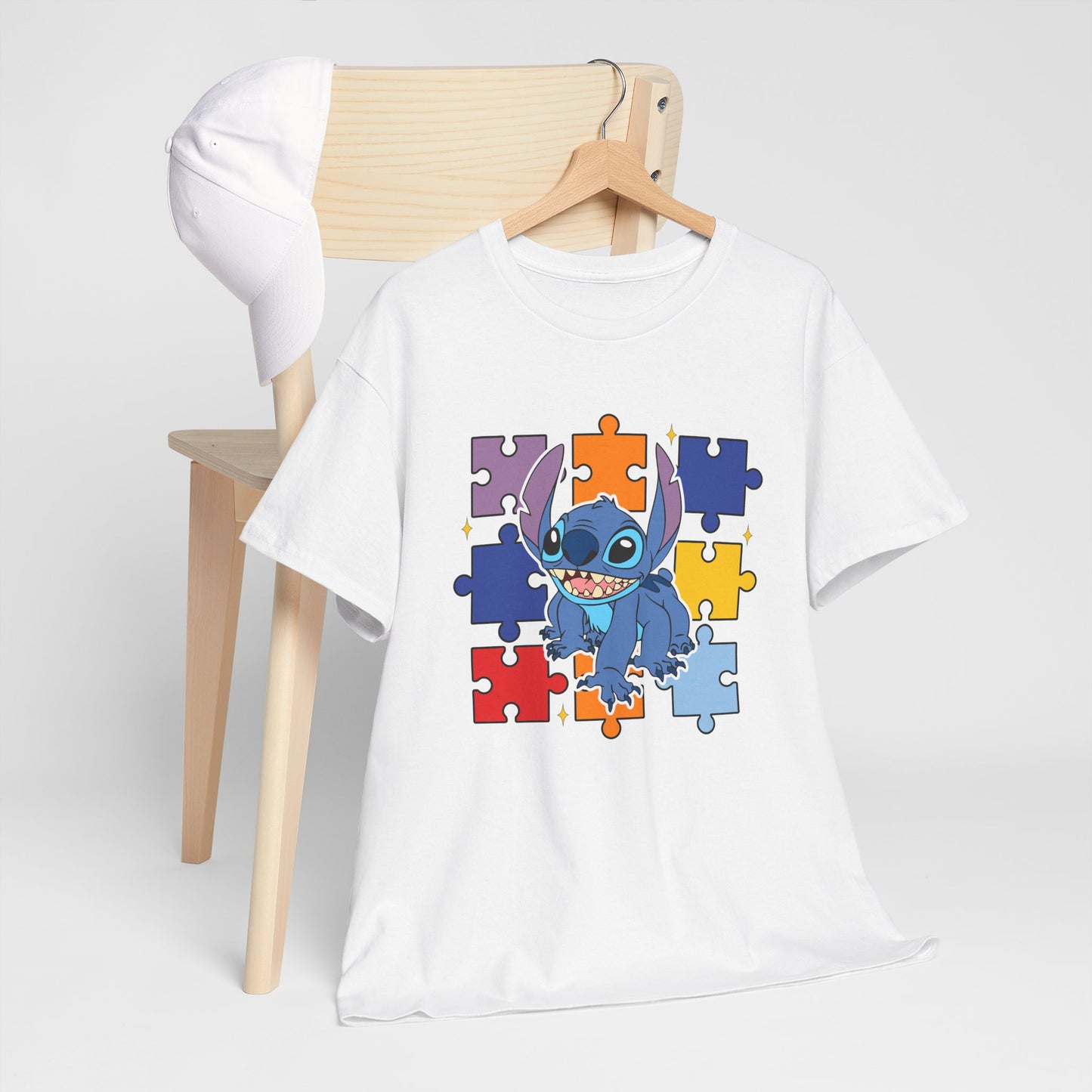 Puzzle Pieces Tee — Cute Blue Alien Character on Colorful Autism Puzzle Background
