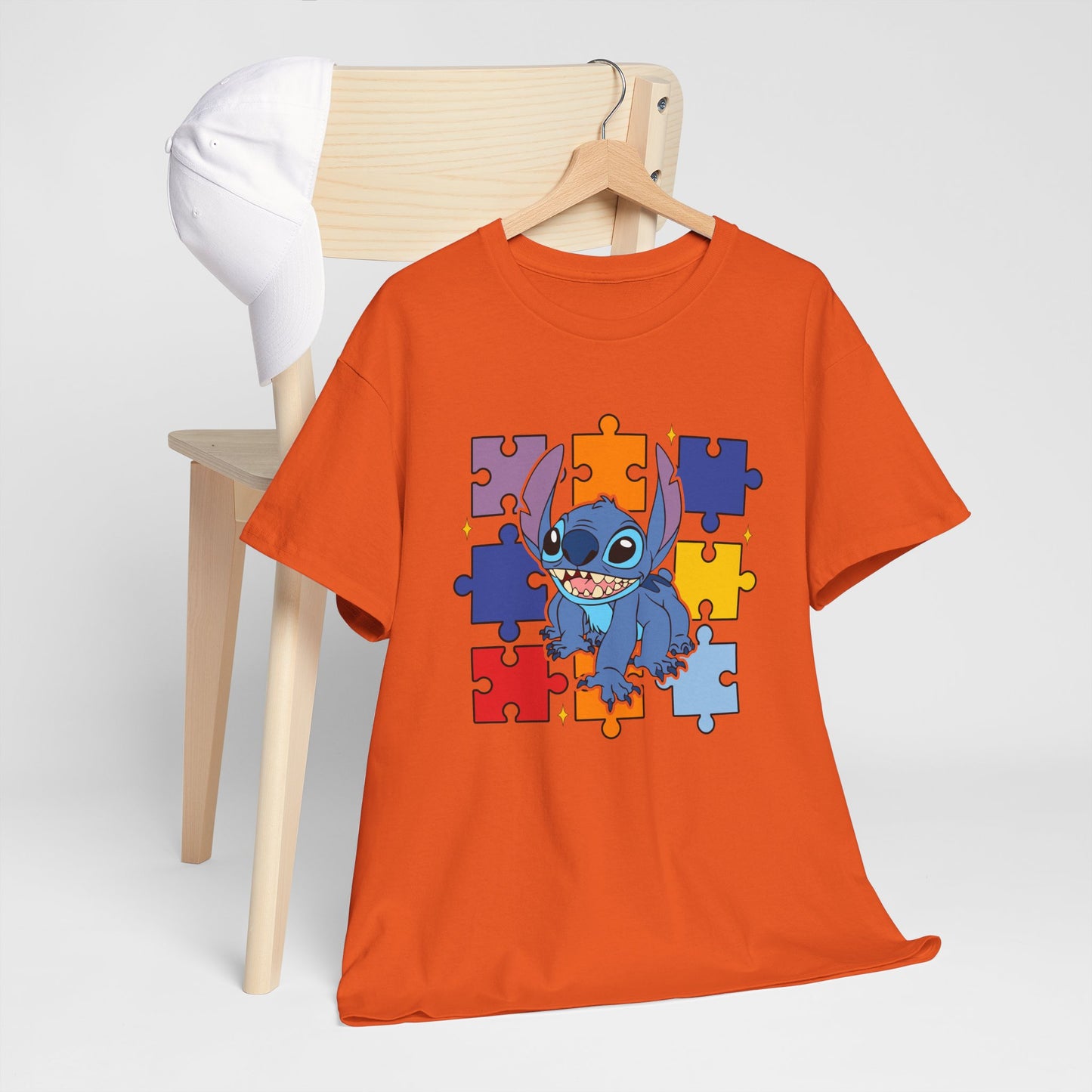 Puzzle Pieces Tee — Cute Blue Alien Character on Colorful Autism Puzzle Background