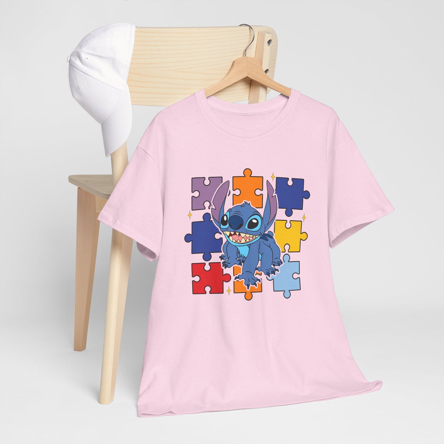 Puzzle Pieces Tee — Cute Blue Alien Character on Colorful Autism Puzzle Background