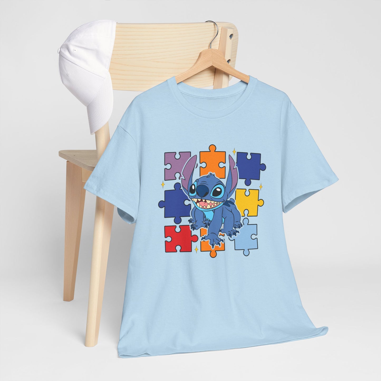 Puzzle Pieces Tee — Cute Blue Alien Character on Colorful Autism Puzzle Background