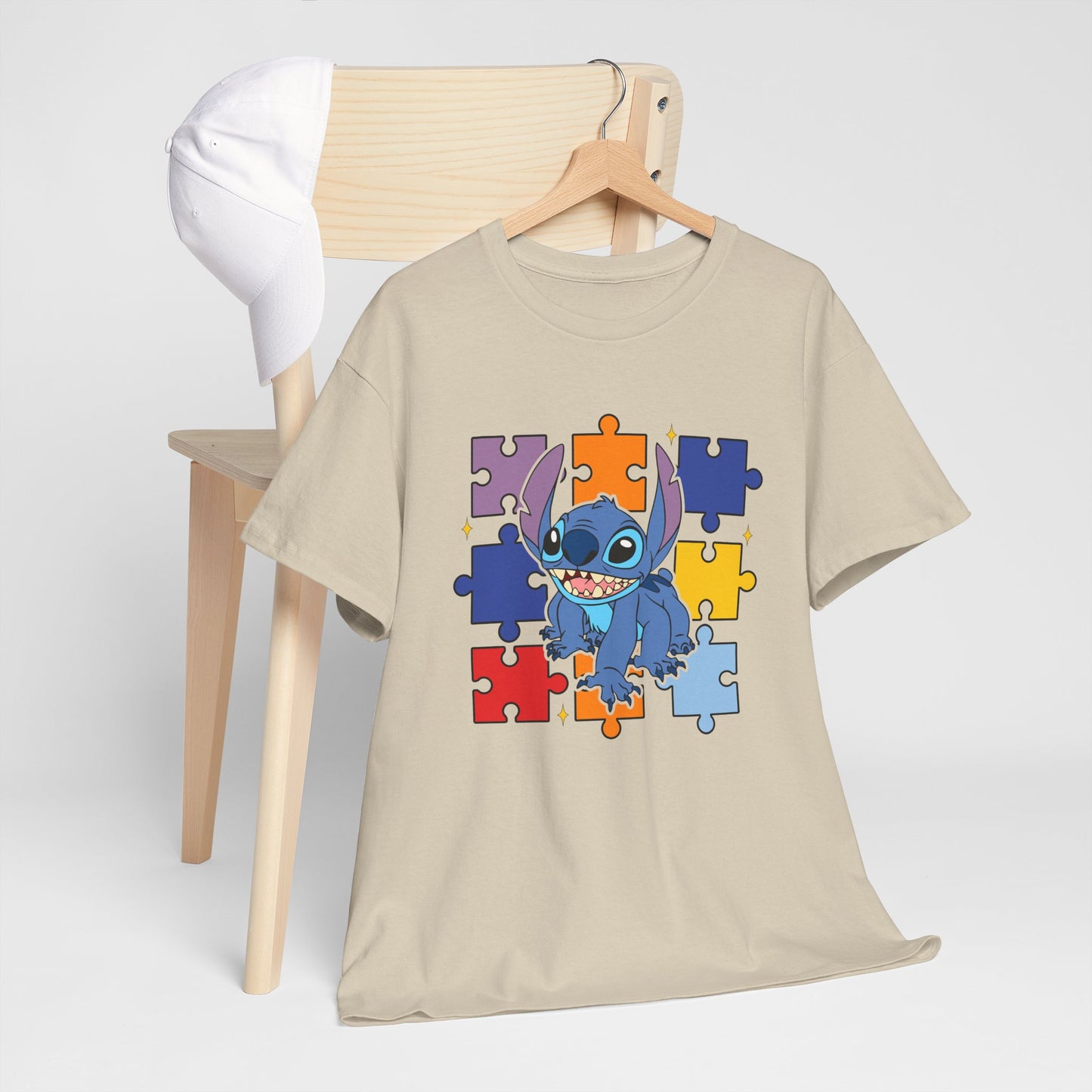 Puzzle Pieces Tee — Cute Blue Alien Character on Colorful Autism Puzzle Background