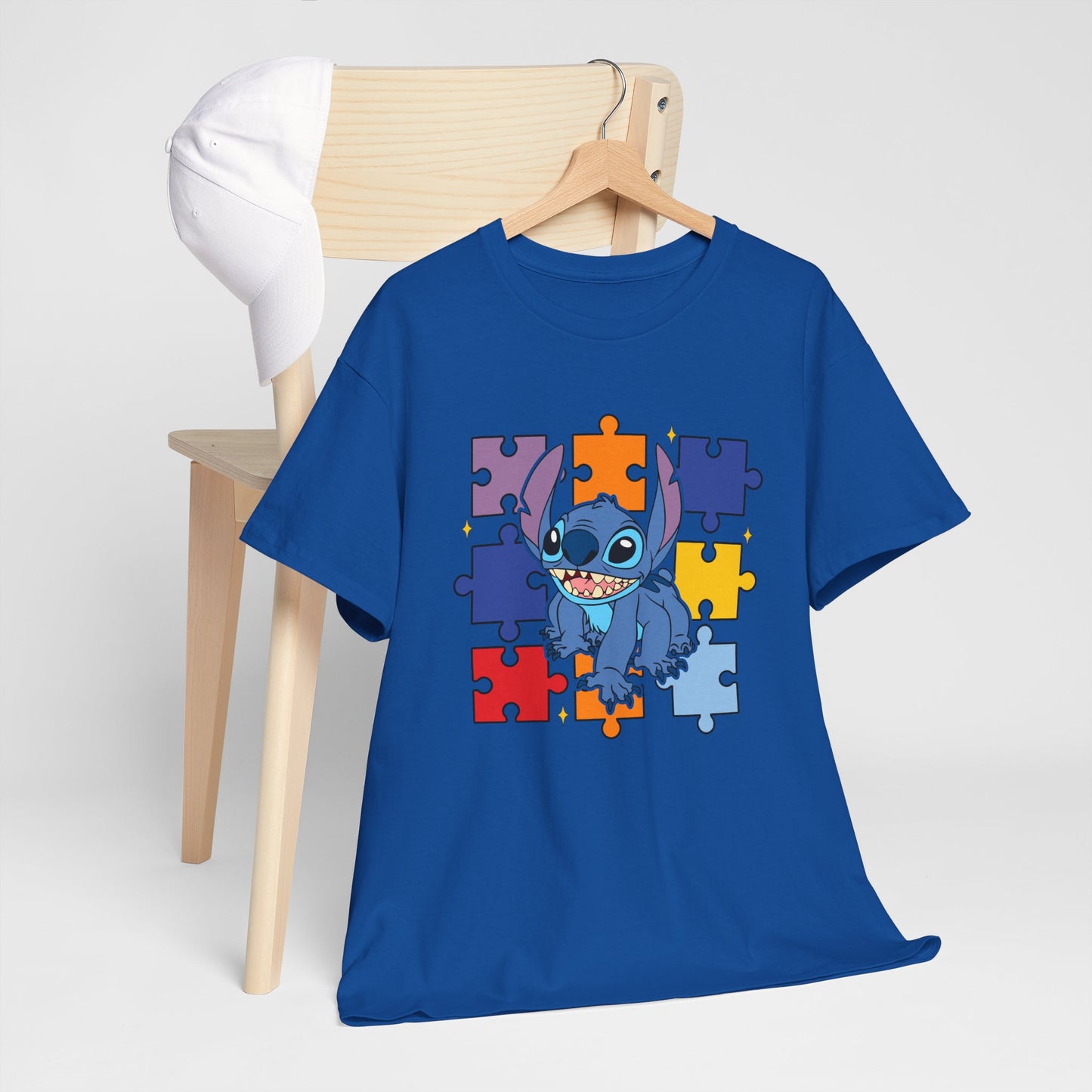 Puzzle Pieces Tee — Cute Blue Alien Character on Colorful Autism Puzzle Background